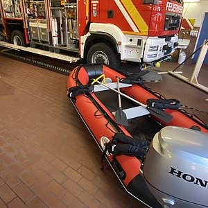 Feuerwehrauto und Rettungsboot in einer Halle